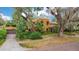 Charming Spanish-style home featuring a stucco exterior, lush landscaping, and a tiled roof at 1141 S Osceola Ave, Orlando, FL 32806