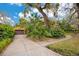 Attached two-car garage with brick driveway surrounded by mature landscaping at 1141 S Osceola Ave, Orlando, FL 32806