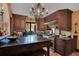 View of kitchen with tile floor, dark wood cabinets and an island with seating at 1141 S Osceola Ave, Orlando, FL 32806