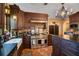 Warm kitchen featuring stainless steel appliances, terracotta flooring, dark countertops and wood cabinets at 1141 S Osceola Ave, Orlando, FL 32806