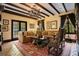 Living room with beamed ceilings, tile floor, and elegant furniture at 1141 S Osceola Ave, Orlando, FL 32806
