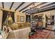 Comfortable living room featuring beamed ceilings, tile floor, and elegant furniture at 1141 S Osceola Ave, Orlando, FL 32806