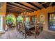 Covered outdoor dining area with chandelier, seating and access to a lush green backyard at 1141 S Osceola Ave, Orlando, FL 32806