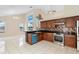 Bright kitchen with tile floors, modern stainless steel appliances, and plenty of cabinet space at 12543 Waterhaven Cir, Orlando, FL 32828