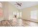 Bedroom features wood-look floors, neutral walls, and a doorway to a private bathroom at 12543 Waterhaven Cir, Orlando, FL 32828