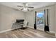 Bright bedroom featuring sleek laminate floors, a ceiling fan, and ample natural light at 131 Woodbury Pines Cir, Orlando, FL 32828