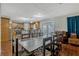 Open dining area with wood floors, connecting to kitchen and outdoor patio at 131 Woodbury Pines Cir, Orlando, FL 32828