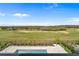 Aerial view features a backyard pool, lush landscaping and manicured lawns backing to a golf course at 15843 Vetta Dr, Bella Collina, FL 34756