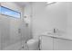 Modern bathroom with white vanity, glass enclosed shower, and bright natural light at 15843 Vetta Dr, Bella Collina, FL 34756
