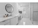 Modern bathroom with double vanities, sleek fixtures, and a walk-in shower with marble accents at 15843 Vetta Dr, Bella Collina, FL 34756