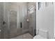 Contemporary bathroom featuring a spacious glass-enclosed shower and modern toilet at 15843 Vetta Dr, Bella Collina, FL 34756