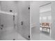 Modern bathroom featuring a glass-enclosed shower and adjacent vanity space with elegant finishes at 15843 Vetta Dr, Bella Collina, FL 34756