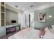 Stylish bedroom with built-in desk, ensuite bathroom, and modern decor at 15843 Vetta Dr, Bella Collina, FL 34756