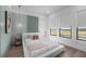 Stylish bedroom with calming wall color, golf course views, and modern decor offers a relaxing space at 15843 Vetta Dr, Bella Collina, FL 34756