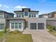Contemporary two-story home boasts a paver driveway, two-car garage and manicured landscaping at 15843 Vetta Dr, Bella Collina, FL 34756