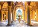Grand entryway featuring a stunning water fountain with pillars and intricate chandeliers at 15843 Vetta Dr, Bella Collina, FL 34756