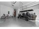 Spacious garage with a golf cart, bikes, and plenty of storage space at 15843 Vetta Dr, Bella Collina, FL 34756