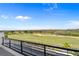 Balcony view overlooking a lush golf course on a sunny day with a vibrant blue sky at 15843 Vetta Dr, Bella Collina, FL 34756