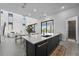 Bright kitchen featuring an island with bar seating, modern appliances, and large sliding doors to the outdoors at 15843 Vetta Dr, Bella Collina, FL 34756