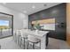 A modern kitchen featuring a center island with bar seating, sleek cabinetry, and stainless steel appliances at 15843 Vetta Dr, Bella Collina, FL 34756