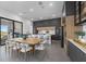 Open-concept kitchen featuring modern cabinetry, a dining table, and an island with barstool seating at 15843 Vetta Dr, Bella Collina, FL 34756
