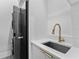 Functional laundry room with stackable washer/dryer and a modern sink with sleek fixtures at 15843 Vetta Dr, Bella Collina, FL 34756