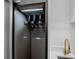 Modern laundry room featuring a Samsung Air Dresser and a gold faucet sink at 15843 Vetta Dr, Bella Collina, FL 34756