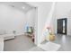 Bright, modern living room with minimalist decor, white walls, and sleek tile flooring at 15843 Vetta Dr, Bella Collina, FL 34756