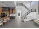 Open-concept living room features a staircase, high ceilings, and lots of natural light at 15843 Vetta Dr, Bella Collina, FL 34756
