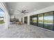 Spacious covered patio with outdoor kitchen, ceiling fan, and seamless access to the indoor living spaces at 15843 Vetta Dr, Bella Collina, FL 34756