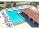 Aerial view of a large community pool with plenty of lounge chairs and a shaded area at 15843 Vetta Dr, Bella Collina, FL 34756