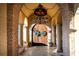 Elegant entrance to a spa featuring arched brickwork and decorative wreaths at 15843 Vetta Dr, Bella Collina, FL 34756