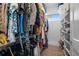 Walk-in closet offers custom storage solutions for organizing clothing, shoes and accessories at 15843 Vetta Dr, Bella Collina, FL 34756