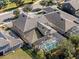 Aerial shot shows a house with a screened-in pool and a well-maintained lawn at 16310 Rock Coast Dr, Winter Garden, FL 34787