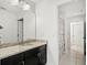 Bathroom featuring a granite countertop, dark cabinets, framed mirror, and tile floors at 16310 Rock Coast Dr, Winter Garden, FL 34787