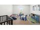 bedroom featuring a crib, single bed, play area, and organized storage, perfect for playtime and relaxation at 16310 Rock Coast Dr, Winter Garden, FL 34787