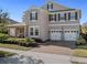 Charming two-story home featuring a three-car garage, covered porch, and well-maintained landscaping at 16310 Rock Coast Dr, Winter Garden, FL 34787