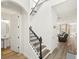 Open foyer with staircase and wrought iron railing, flowing into the home's living spaces at 16310 Rock Coast Dr, Winter Garden, FL 34787