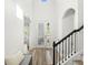 Bright foyer featuring wood floors, staircase with black iron spindles and lots of natural light at 16310 Rock Coast Dr, Winter Garden, FL 34787