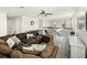 Spacious upstairs living room with hardwood-style floors, a sectional sofa, a ceiling fan, and a television at 16310 Rock Coast Dr, Winter Garden, FL 34787