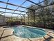 Backyard pool area with a screened enclosure and patio with tiled flooring at 16310 Rock Coast Dr, Winter Garden, FL 34787