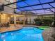 A kidney shaped pool with a spa, brick pavers, covered patio and manicured landscaping at 16310 Rock Coast Dr, Winter Garden, FL 34787