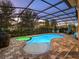 A private screened-in pool features a spa and brick pavers for outdoor enjoyment at 16310 Rock Coast Dr, Winter Garden, FL 34787