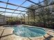 A private screened-in pool with brick pavers offers a relaxing backyard retreat at 16310 Rock Coast Dr, Winter Garden, FL 34787