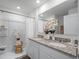 Elegant bathroom with a double granite vanity, white cabinetry, and a walk-in shower at 16323 Lakelet Aly, Winter Garden, FL 34787