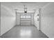 Spacious garage with epoxy flooring and white block walls, ready for parking and storage at 16323 Lakelet Aly, Winter Garden, FL 34787
