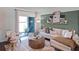 A cozy living room with a comfortable sofa, stylish decor, and sliding glass doors to the patio at 16323 Lakelet Aly, Winter Garden, FL 34787
