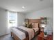 Bright main bedroom with a lake view and stylish furnishings at 16323 Lakelet Aly, Winter Garden, FL 34787