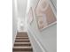 Carpeted stairway, neutrally decorated with artwork at 16323 Lakelet Aly, Winter Garden, FL 34787