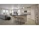 Open-concept kitchen and living room with a large island, stainless steel appliances, and sleek countertops at 167 Aulin Ave, Oviedo, FL 32765